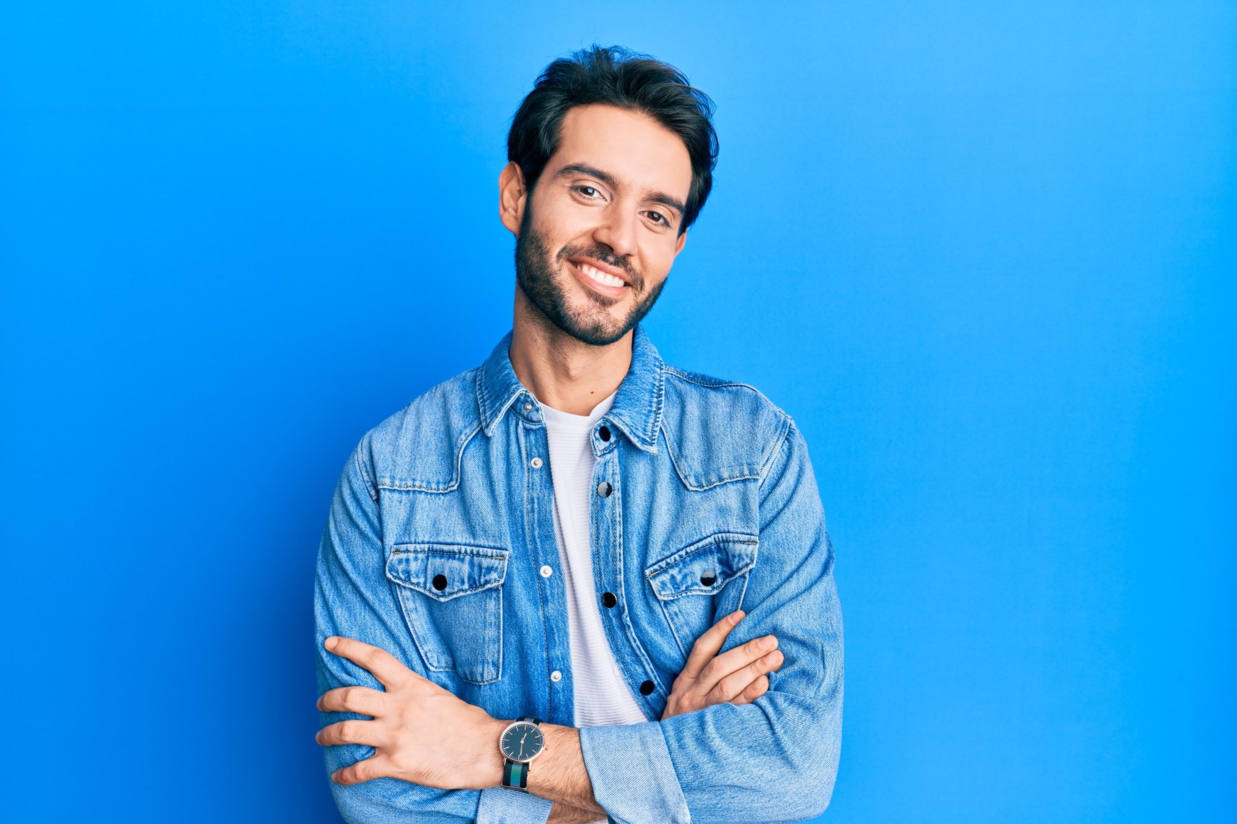 Young hispanic man wearing casual clothes happy face smiling with crossed arms looking at the camera. positive person.